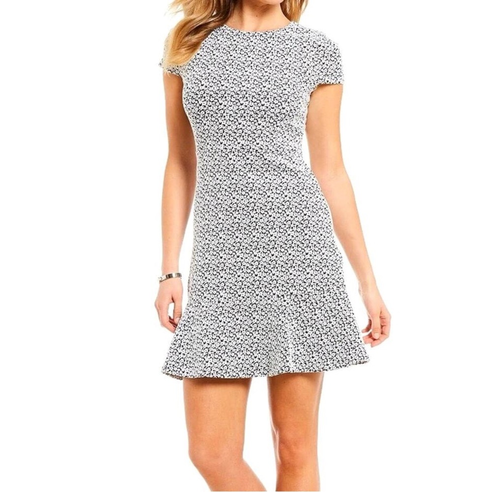 Michael Kors black and white floral A-line dress with wavy flared bottom.